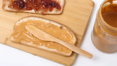 a wooden spoon next to a bowl of food