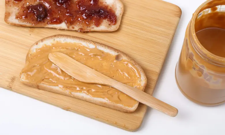 a wooden spoon next to a bowl of food