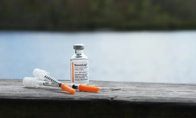 orange and white plastic bottle on brown wooden table