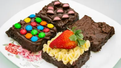 a white plate topped with brownies covered in candy