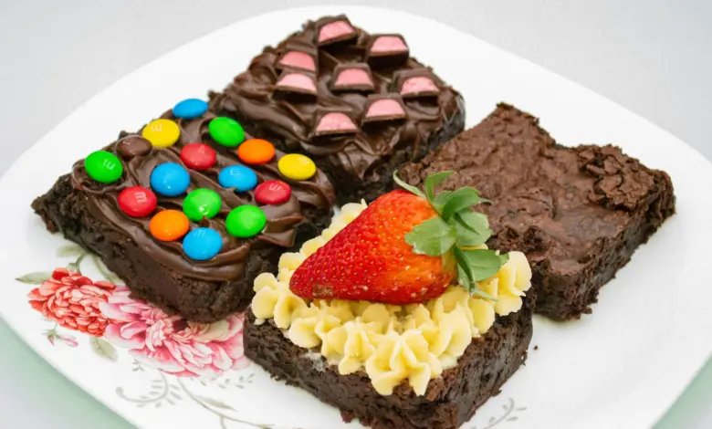 a white plate topped with brownies covered in candy