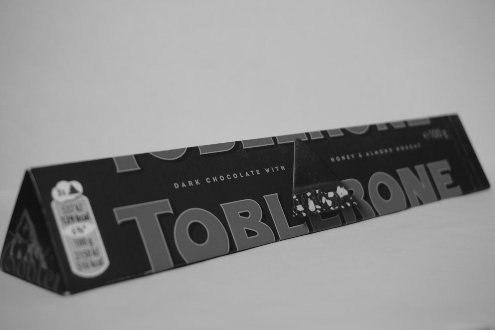 A black and white photo of a tube of toothpaste