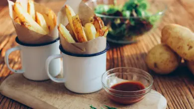 potato fries on mugs beside sauce