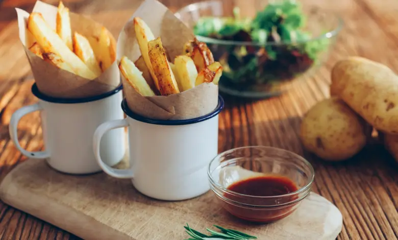 potato fries on mugs beside sauce