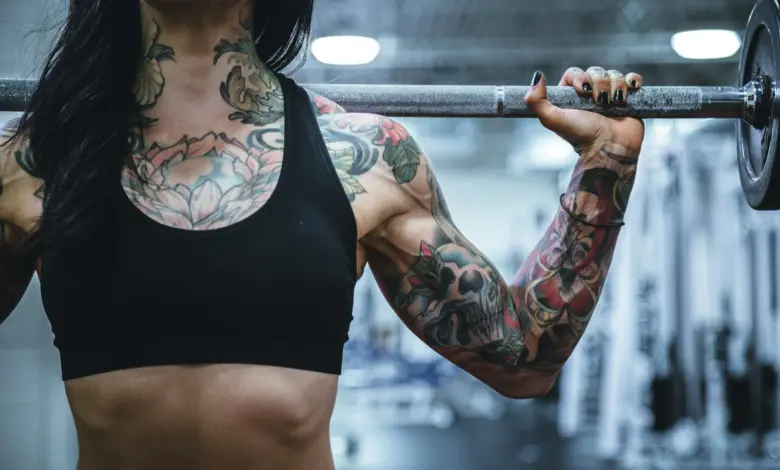 woman carrying barbell